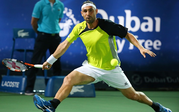 Marcos Baghdatis chases down a forehand during the final. Photo: Marwan Naamani/AFP/Getty Images