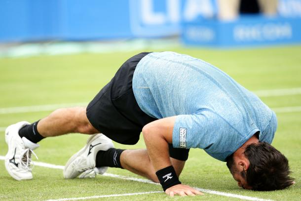 Baghdatis kisses the grass on Centre Court after his victory. Photo: Getty