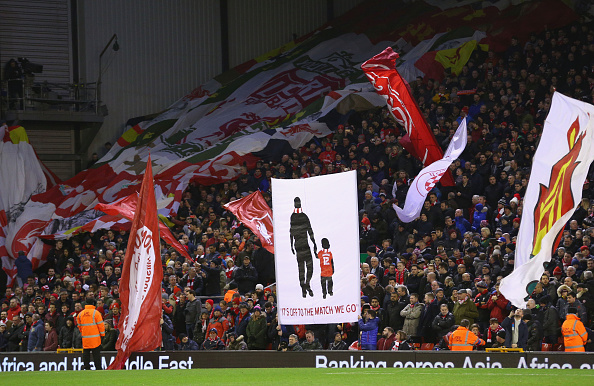 Liverpool fans wave flags in support of the Reds (Getty)