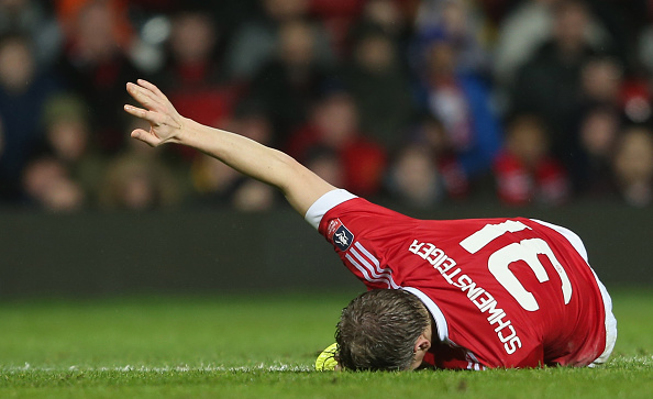 Bastian Schweinsteiger lies injured on the floor.