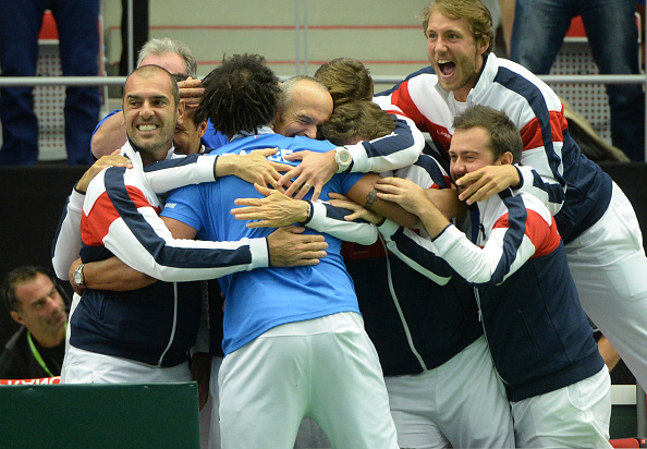 Captain of French Davis Cup team Yannick Noah celebrates with teammates after Pierre-Hugues Herbert of France and Nicolas Mahut win against Radek Stepanek and Lukas Rosol (Photo: Michal Cizek/Getty Images)