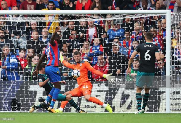 Benteke forces Forster into a point-blank save. Source | Getty Images.