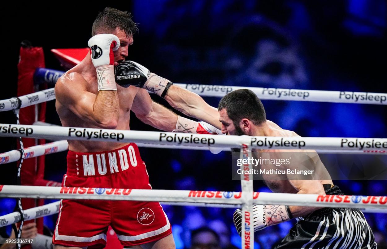 QUEBEC CITY, CANADA - JANUARY 13: Artur Beterbiev of Canada punches <strong><a  data-cke-saved-href='https://www.vavel.com/en/more-sport/2020/11/17/1047241-saul-canelo-alverez-returns-against-callum-smith-december-19th.html' href='https://www.vavel.com/en/more-sport/2020/11/17/1047241-saul-canelo-alverez-returns-against-callum-smith-december-19th.html'>Callum Smith</a></strong> of the United Kingdom during their WBC, IBF and WBO light-heavyweight world championship fight at Videotron Centre on January 13, 2024 in Quebec City, Canada. (Photo by Mathieu Belanger/Getty Images)