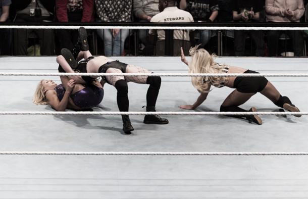 Paige and Charlotte locked up in a submission.