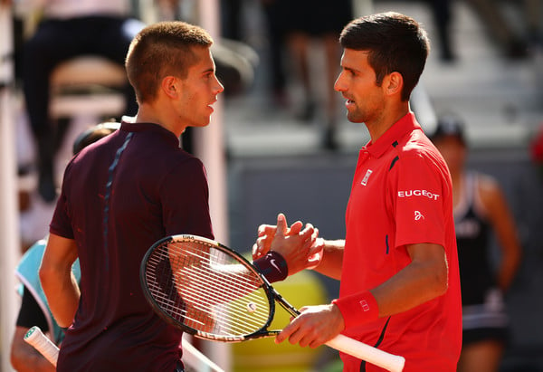 Borna Coric and Novak Djokovic in Mutua Madrid Open action. Photo: Clive Brunskill/Getty Images