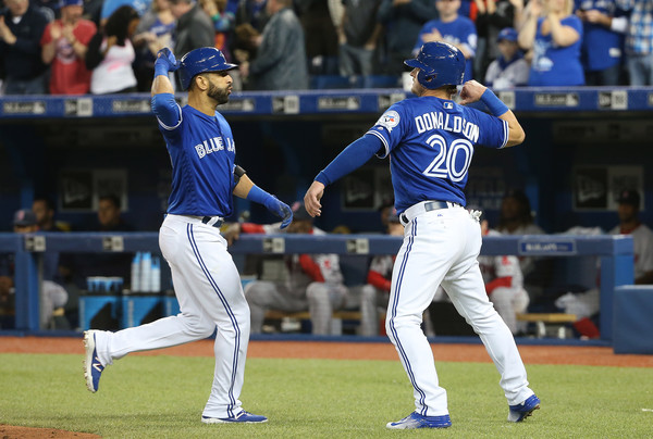 Jose Bautista and Josh Donaldson celebrate after Bautista's home run in the bottom of the first inning. (Source: Tom Szczerbowski/Getty Images North America)
