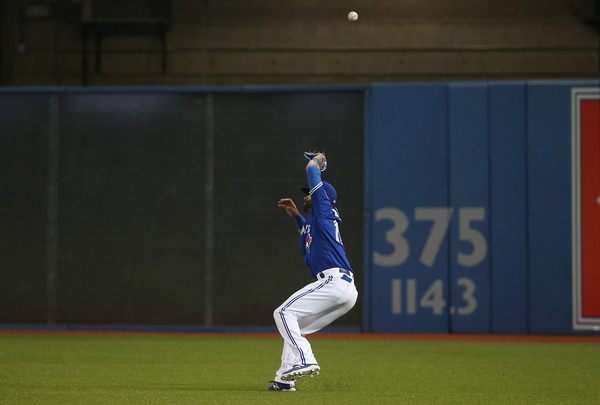 Jose Bautista mishandles a bloop hit by Hanley Ramirez, leading to a triple. (Source: Tom Szczerbowski/Getty Images North America)
