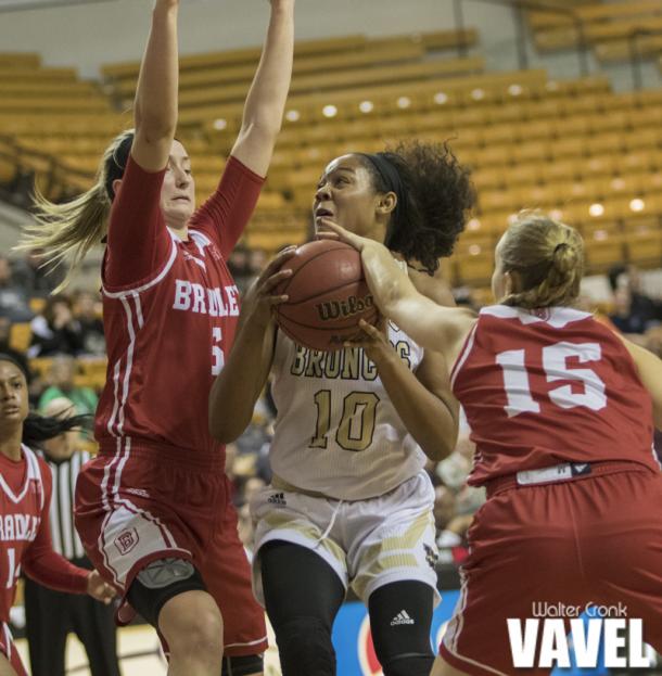 Emily Eshoo (15) gets a hand on the ball while Breanna Mobley (10) go's for the basket. Photo: Walter Cronk