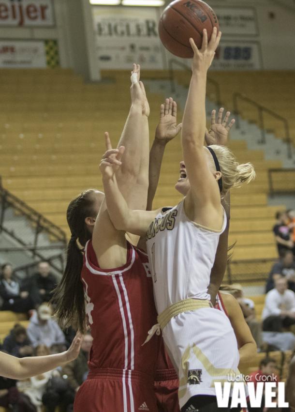 Meredith Shipman (1) go's for two points above a pair of Bradley University players. Photo: Walter Cronk