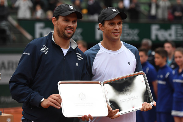 The Bryans hold their runner-up trophies at the French Open. Photo: Dennis Grombkowski/Getty Images