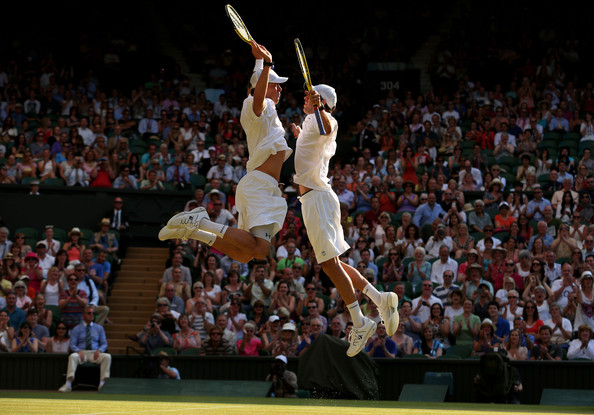 The Bryans do their famous chest bump after winning their third Wimbledon title in 2013. Photo: Julian Finney/Getty Images