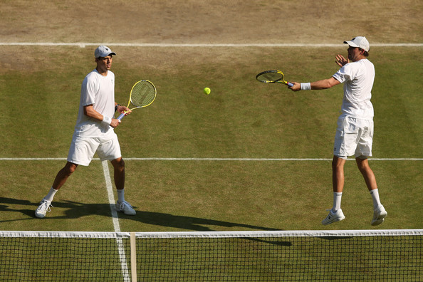 Bob Bryan (right) hits a backhand volley as Mike looks on during the 2013 Wimbledon final. Photo: Clive Brunskill/Getty Images