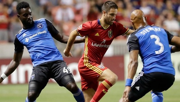 Juan Manuel Martinez (center) dribbles past Simon Dawkins (left) and Jordan Stewart (right) in a July 22, 2016 match between Real Salt Lake and the San Jose Earthquakes at Rio Tinto Stadium. | Photo:: Jeff Swinger-USA TODAY Sports