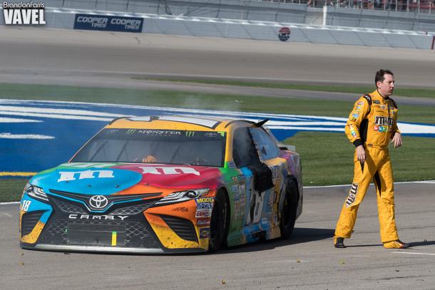 Kyle Busch walks away from his car.