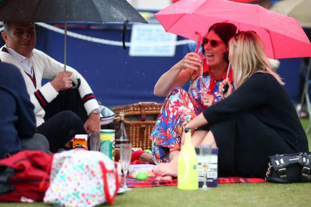 The crowd in Eastbourne tried their best to keep their spirits up during the poor weather (Getty/Charlie Crowhurst)