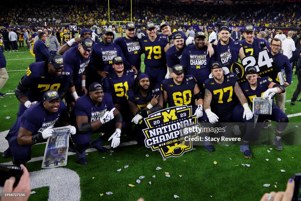 Drake Nugent #60 of the Michigan Wolverines poses with teammates after defeating the Washington Huskies during the 2024 CFP National Championship game at NRG Stadium on January 08, 2024 in Houston, Texas. Michigan defeated Washington 34-13. (Photo by Stacy Revere/Getty Images)