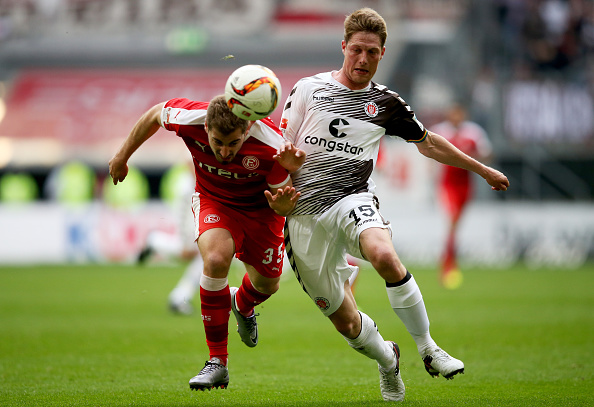 Mavrias battles Daniel Buballa for possession. | Image credit: Lars Baron/Bongarts/Getty Images