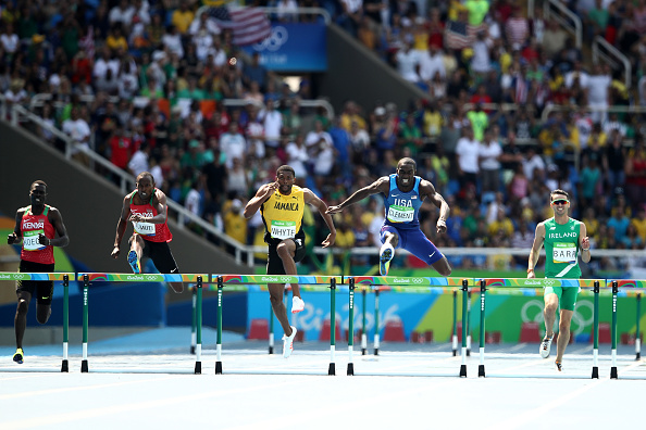 Kerron Clement leads the field over the final hurdle (Getty/Cameron Spencer)