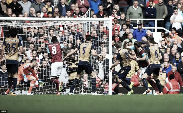 Above: Andy Carroll scoring his first of three goals in West Ham's 3-3 draw with Arsenal | PA