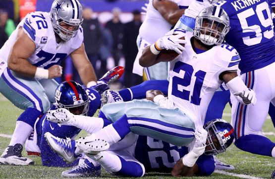 Dallas Cowboys running back Ezekiel Elliott tackled by New York Giants linebacker Jonathan Casillas | Source:  Al Bello - Getty Images