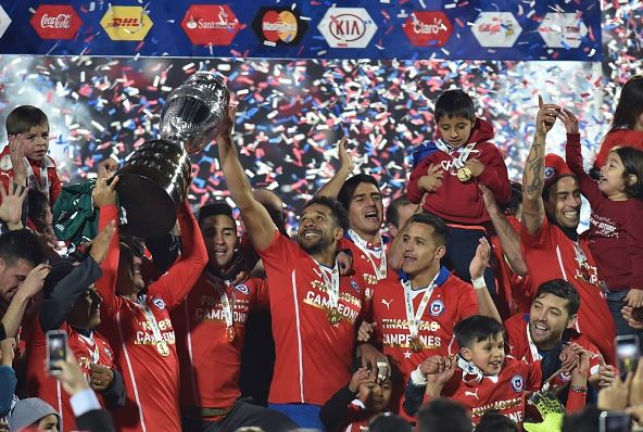 Chilean players celebrate after winning the 2015 Copa America football championship final against Argentina, in Santiago, Chile, on July 4, 2015. Chile won 4-1 (0-0). AFP PHOTO / NELSON ALMEIDA (Photo credit should read NELSON ALMEIDA/AFP/Getty Images