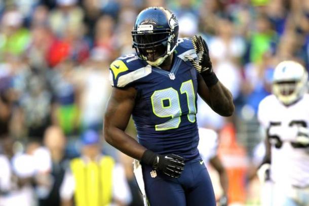 Seattle Seahawks defensive end Chris Clemons celebrates in an NFL game against the Oakland Raiders. Image via AP Images. 