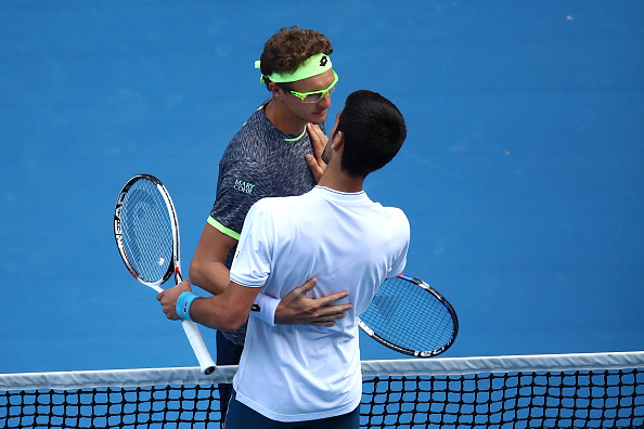 Denis Istomin and Novak Djokovic after the match (Getty/Clive Brunskill)