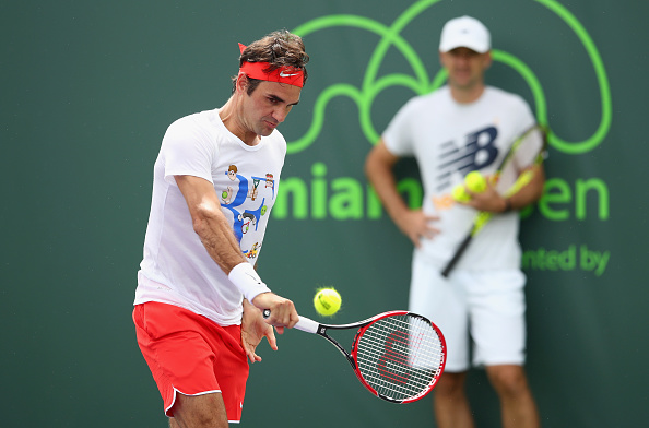 Federer holds a practice session in Miami as Ljubicic looks on from the background. Credit: Clive Brunskill/Getty Images