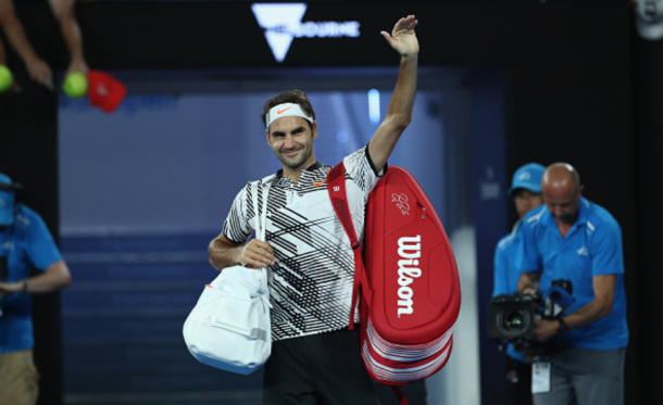 Federer thanks the crowd on Rod Laver Arena after the late-night victory. Credit: Clive Brunskill/Getty Images