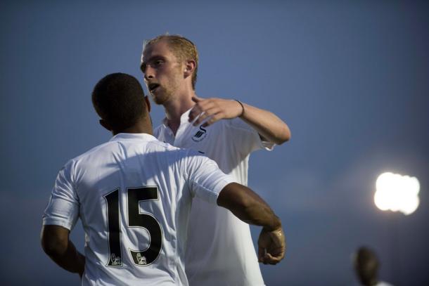 Goal-scorers Wayne Routledge (left) and Oliver McBurnie (right) celebrate Swansea's 4-0 win. (Photo: Swansea City AFC)