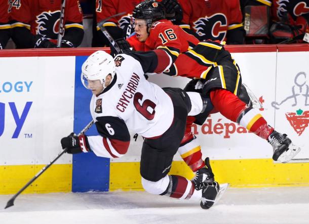 The Arizona Coyotes' Jakob Chychrun fights off the Flames Spencer Foo. (Photo: Larry MacDougal The Candian Press via AP)