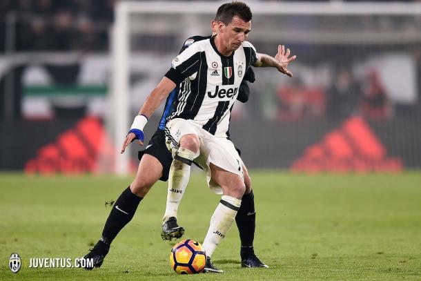 Mandžukić protege la pelota ante la presión de un jugador bergamasco | Foto: Juventus FC