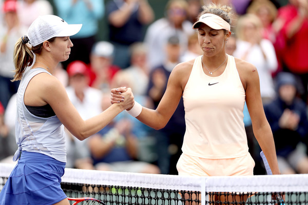 Both players meet at the net for the handshake after Collins sealed the biggest win of her career | Photo: Matthew Stockman/Getty Images North America