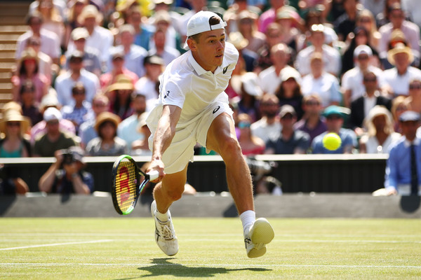 Alex de Minaur lunges for a forehand volley during his senior tour Centre Court debut. Photo: Clive Brunskill/Getty Images