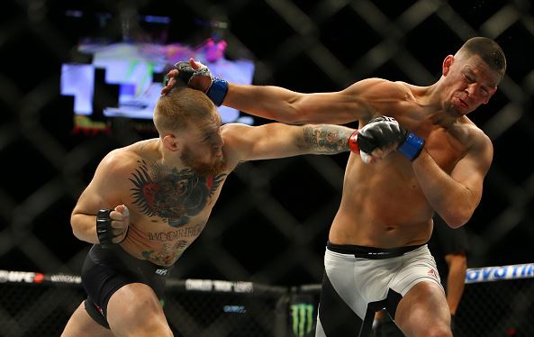 Conor McGregor punches Nate Diaz during UFC 196 at the MGM Grand Garden Arena on March 5, 2016 in Las Vegas, Nevada. (Photo by Rey Del Rio/Getty Images