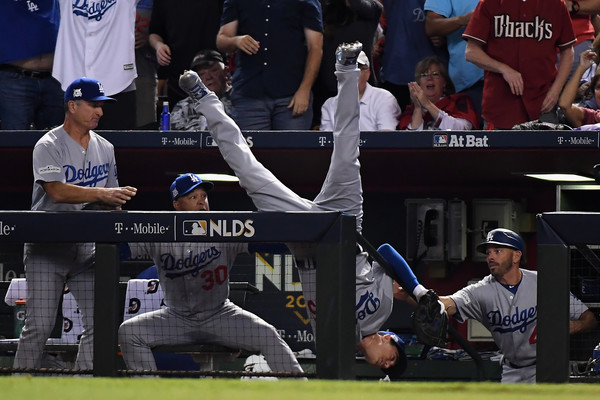 Cody Bellinger #35 of the Los Angeles Dodgers tumbles into the dugout after catching a foul ball during the fifth inning of the National League Divisional Series. |Source: Norm Hall/Getty Images North America|