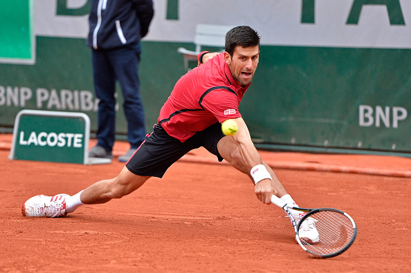 Djokovic slides into a backhand during his victory. Photo: Aurelien Meunier/Getty Images
