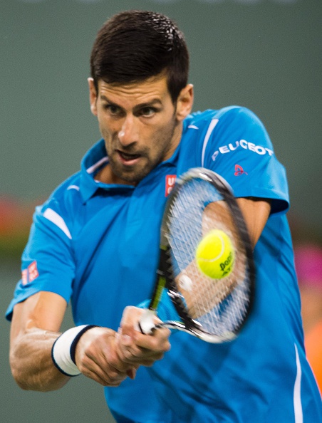 Novak Djokovic hits a backhand during his win on Tuesday. Photo: Robyn Beck/AFP/Getty Images