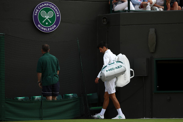 Djokovic walks off the court at Wimbledon following his injury retirement at Wimbledon. Photo: Julian Finney/Getty Images