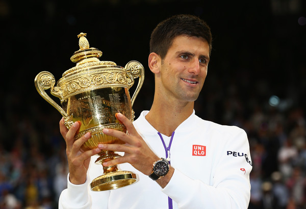 Novak Djokovic hoists his Wimbledon trophy in 2015, his last victory at the All England Club. Photo: Clive Brunskill/Getty Images