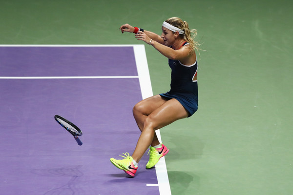 Dominika Cibulkova falls to the ground in celebration after defeating Angelique Kerber in the final of the 2016 BNP Paribas WTA Finals Singapore presented by SC Global. | Photo: Julian Finney/Getty Images