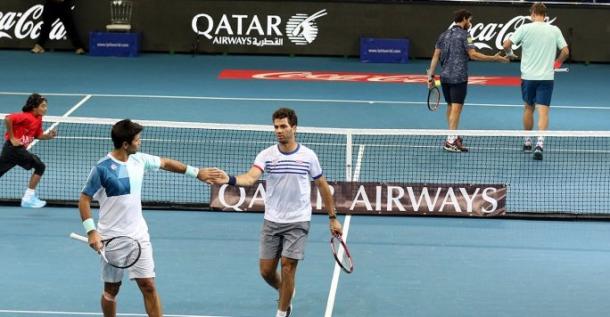The doubles teams high five during their set on Friday. Photo: IPTL