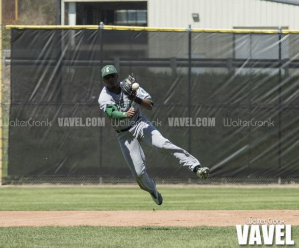 Marquise Gill (4) makes the leaping throw to 1st base to get the out. Photo: Walter Cronk