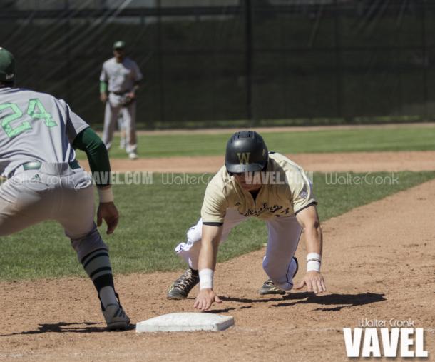 Tyler Frank (17) dives back to 1st base. Photo: Walter Cronk