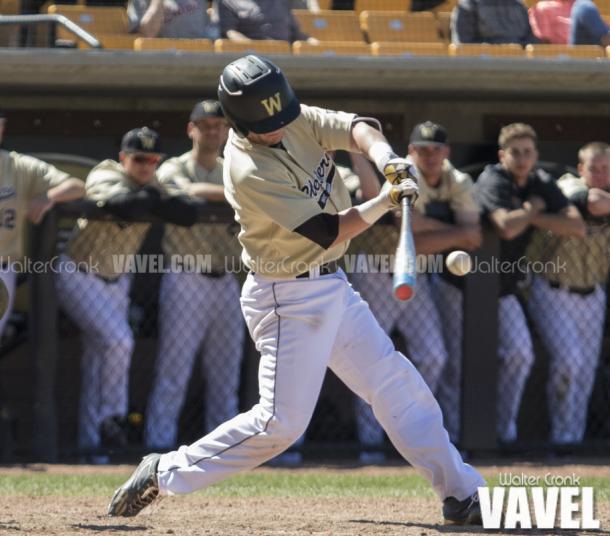 Connor Smith (2) hits a double in the bottom of the 8th inning to score 2 more runs. Photo: Walter Cronk