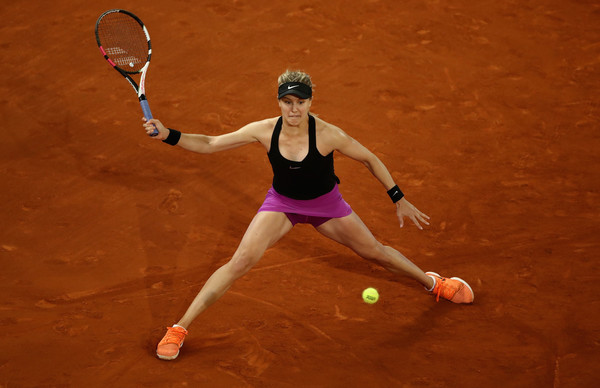 Eugenie Bouchard stretches to hit a defensive forehand during her second-round match against Maria Sharapova at the 2017 Mutua Madrid Open. | Photo: Julian Finney/Getty Images