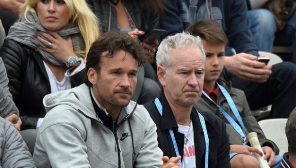 Carlos Moya (left) and John McEnroe watch Milos Raonic play at the 2016 French Open. Photo: Getty Images