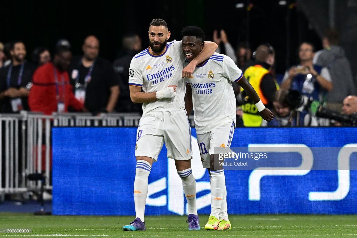 Vinícius Júnior of Real Madrid CF celebrates with Karim Benzema of Real Madrid CF after scoring his side's first goal of the match during the UEFA Champions League final between Liverpool FC and Real Madrid at Stade de France on May 28, 2022 in Paris, France. (Photo by Mattia Ozbot/Getty Images)