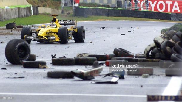 Giancarlo Fisichella weaves his way through the detritus. | Photo: Getty Images/Alexander Hassenstein