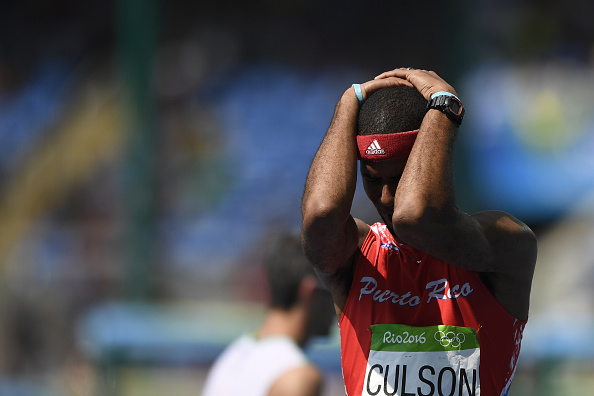 Javier Culson holds his head in his hand after false-starting in the 400-meter hurdles final (AFP/Fabrice Coffrini)